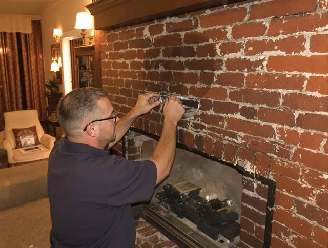 Greenwich Chimney Sweep expert fixing a fireplace in Greenwich, CT